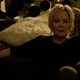 Melanie usually sits or smokes—often both at the same time.